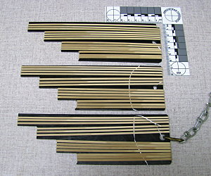 Fig. 1 Rubber bands streatched to different lenths on plastic sheet. Sheets were then deployed in sand and a river until they degraded.